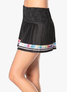 Court couture that bring contemporary styling to tennis in this performance smocked skirt. Done in an ultra lightweight performance fabric it also features a mesh polka dot print, bold ombre racing stripe border and a contrast parrot blue shortie for a pop of color as you move across the court. Black Pleated Tennis Skirt For Sports, Sporty Black Pleated Skort, Sporty Black Tennis Skirt With Elastic Waistband, Sports Black Pleated Skort, Black Pleated Sporty Bottoms, Black Sporty Pleated Bottoms, Sporty Black Pleated Bottoms, Black Athleisure Skort With Lined Skirt, Athleisure Black Lined Skort