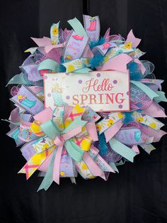 a colorful wreath that says hello spring on it