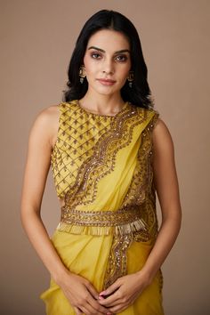 Yellow scallop border saree with floral embroidery in sequin, cutdana and nakshi. Paired with embroidered, padded blouse and petticoat.
Components: 3
Pattern: Embroidered
Type Of Work: Nakshi, Cutdana, Sitara
Neckline: Round
Sleeve Type: Sleeveless
Fabric: Saree and Blouse: Organza, Petticoat: Crepe
Color: Yellow
Other Details: 
Floral pattern
Back cutout
Note: Belt worn by the model is not for sale
Occasion: Bride,Wedding - Aza Fashions Transitional Bollywood Style Embellished Pre-draped Saree, Anarkali Style Embellished Pre-draped Saree In Tissue Silk, Embellished Tissue Silk Saree Set, Bollywood Style Embellished Festive Pre-draped Saree, Traditional Embellished Tissue Silk Pre-draped Saree, Festive Pre-draped Chinon Saree For Reception, Traditional Embellished Pre-draped Saree For Festive Season, Festive Embellished Art Silk Saree, Embellished Art Silk Anarkali Blouse Piece