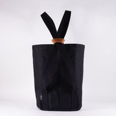 a black tote bag with a wooden handle