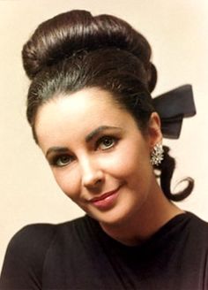 a woman wearing a black shirt and a bow in her hair