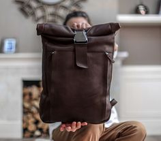 "This leather backpack is made of durable and sturdy cowhide that makes it ideal for all your daily necessities: a laptop, wallet, shirt, pair of shoes, water bottle, charger, documents, wallet, phone and more!  ✅ Made from Full-grain Italian leather ✅ Roll top entry with quick-release airplane buckle ✅ Expandable main compartment ✅ Solid steel hardware ✅ Adjustable leather shoulder straps ✅ Padded back ✅ Front exterior pocket with two vertical zippers ✅ Large interior padded slip pocket for laptop up to 17\" ✅ Three interior pockets ✅ Fully lined in twill SIZE ✅ Big: 15\"W x 18\"H x 4\"D (rolled) 3.2 lbs ✅ Small: 10\"W x 13\"H x 3\"D (rolled) 2.5 lbs. WATERPROOFING OPTION You can choose a standard or a waterproofed leather. We treat the cut leather before it's assembled with a professiona Elegant Laptop Bag, Work Backpack Women, Backpack For Laptop, Womens Work Bag, Laptop Backpack Women, Leather Backpack For Men, Leather Briefcase Men, Camera Backpack, Laptop Bag For Women