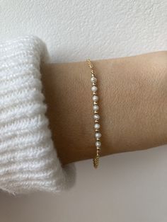 This little bracelet is beautiful in its simplicity! Pearls are also the birthstone for anyone born in the month of June. D E T A I L S  *It features tiny AA+ grade freshwater pearls  l measuring around 2mm. *They are  separated by seamless gold filled/sterling silver beads. *Choose between an 18k gold filled, rose gold filled  or 925 sterling silver chain. *Gold filled is a wonderful alternative to solid gold and unlike gold plating does not rub off. *It closes with a  hallmarked  spring ring clasp measuring 6mm. *Bracelet comes care instructions and a matching crystal information card and is ready for gifting. S I Z I N G* H E L P Choose the length from the drop down menu. Use the length guide as a reference. If unsure choose the extender option which will allow room for adjustment. C A Bridal Bracelet Pearl, Pearl Bracelet Wedding, Bracelet Wedding, Jewellery Gold, Chain Gold, 925 Sterling Silver Chain, Bridal Jewellery, Wedding Bracelet, Sterling Silver Bead