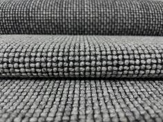 two pieces of gray fabric are stacked on top of each other in this close up photo