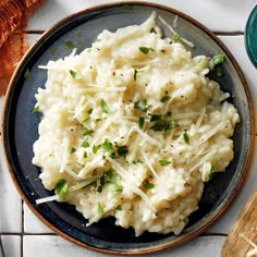 mashed potatoes with parmesan cheese and chives on a plate