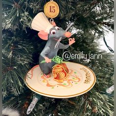 an ornament shaped like a mouse hanging from a christmas tree with the number fifteen on it