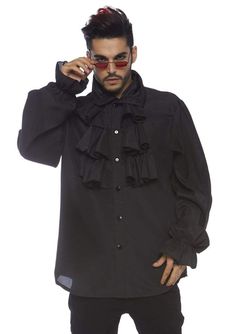 a man in a black shirt and sunglasses is talking on his cell phone while standing against a white background