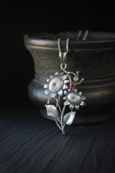 ITEM DESCRIPTION: The size H 3 cm x W 5 cm Weight - 5 g. You can buy it with a silver chain or without it. I made this Sunflower pendant of sterling silver 925, garnet, and citrine. I used these warm stones to make this summer charm brighter and more joyful. These amazing flowers are full of vitality and energy. This is a piece of really modern and detailed jewelry. This handmade necklace will come to you in a gift box - ready for gifting. The parcel will be sent during 1-2 days after payment. D Sterling Silver Jewelry With Large Pendant, Sterling Silver Hallmarked Pendant Necklace, White Gold Jewelry With Large Flower Pendant, Silver Flower Pendant Jewelry Stamped 925, Spiritual Flower Pendant Jewelry, Unique Birthstone Pendant Necklace, Nickel-free Sterling Silver Flower Pendant Necklace, Sterling Silver Flower Pendant Jewelry With Gemstone, Sterling Silver Jewelry With Flower Pendant