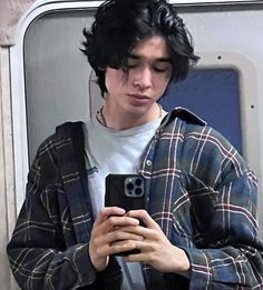 a young man looking at his cell phone