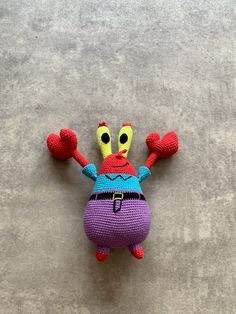 a crocheted stuffed animal that looks like a crab with arms and legs stretched out