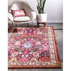 a pink area rug with an ornate design