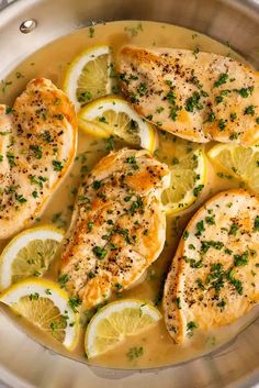 chicken with lemons and herbs in a pan