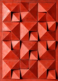 an image of a red wall that is made out of small squares and rectangles