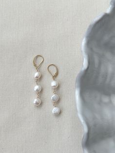 These stunning pearl drop earrings are perfect for your next special occasion! Each earring holds a strand of 3 gorgeous natural shape round Pearls with sensitive skin safe accents. The leverback clasp closure makes sure your earrings stay secure all day and night! * Natural 7x10mm off-round white Pearls * 14K Gold Filled or 925 Sterling Silver comfy and secure 17mm clasps and accents * 2.25 inch length * Made with all hypoallergenic materials 🤍 *Please note for the health and safety of my cust 14k Gold Filled Pearl Drop Earrings For Anniversary, 14k Gold-filled Pearl Pendant Earrings For Wedding, Single 14k Gold Filled Linear Earring For Weddings, 14k Gold Filled Single Linear Earring For Wedding, Elegant Pearl Charm Earrings In 14k Gold Filled, Classic Pearl Pendant Earrings In 14k Gold Filled, Elegant Teardrop 14k Gold Filled Earrings, Elegant 14k Gold-filled Earrings With Pearl Charm, Elegant 14k Gold Filled Earrings With Pearl Charm