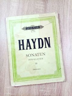 an old book is laying on top of a wooden table with the title, haydon sonaten for klaver