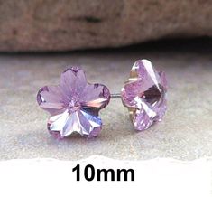 10mm Violet Flower Rhinestone earrings. To get a visual idea of the size refer to the ear pic above. Posts...solid hypo-allergenic surgical steel. Backs...comfort grip hypo-allergenic rubber. Large earrings have a large comfort grip rubber back to support them properly on the ear without sagging. Earrings come to you carded and in my cotton filled gold embossed gift boxes. From our different pics you can see how the same earring can appear different colors in different lighting conditions and wh Swarovski Heart, Flower Stud Earrings, Violet Flower, Purple Rhinestone, Flower Stud, Swarovski Crystal Earrings, Swarovski Earrings, Flower Earrings Studs, Large Earrings