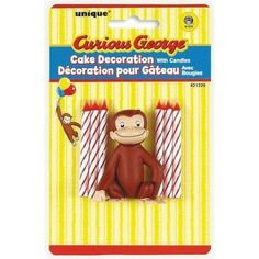 a monkey sitting in front of two candles with the words curious george on it's back