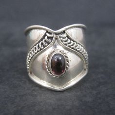 This beautiful, lightweight band ring is sterling silver with a genuine garnet. Measurements: Tapers from 3/4 to 3/8 of an inch wide Size: 6 Marks: 925 Condition: Excellent Silver Garnet Ring Stamped 925, Unique Silver Garnet Rings, Elegant Silver Ruby Toe Ring, Filigree Diamond Ring, Sapphire Halo Ring, Garnet Gem, Garnet Ring, Red Band, Gold Filigree