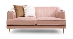 a pink couch with two pillows on it's back and one pillow in the middle