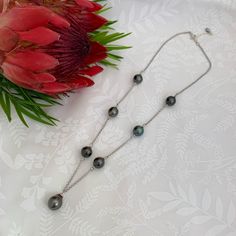 ✨Made with 7 Tahitian pearls, this beautiful necklace has a traditional link style necklace with a pendant style pearl for a unique look . ✨Pearls are all stationary . ✨A simple , timeless and versatile necklace that is sure to please ! ✨Pearls: Size : approx 8-9mm for the side pearls are 9-10mm for the pendant pearl . Surface :Overall good surface quality, have a few minor imperfections but overall smooth and clean surface . Color : Pearl colors may vary . Luster : Good Shape : Slightly circled Tahitian Pearl Chain Necklace With Round Beads, Tahitian Pearl Chain Necklace, Handmade Tahitian Pearl Necklace Gift, Tahitian Pearl Drop Necklace With Round Beads, Tahitian Pearl Drop Jewelry With Round Beads, Classic Tahitian Pearl Round Necklaces, Black Tahitian Pearl Necklace For Gift, Classic Round Tahitian Pearl Necklace, Luxury Tahitian Pearl Round Bead Necklace