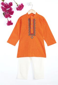 This Orange vibrant 100% cotton kurta pajama offers unique hand work Kutch embroidery at neck. It has stylish embroidery buttons and has Chinese collar kurta with comfortable white pajama's. It is an ideal choice for your little one's festive desires. SIZING TIP : * Please review the size chart for each outfit before making your size selection. more specifically look at the chest and length * If your child currently wears different sizes for top and bottom, please go with the smaller size of the two while picking the outfit FABRIC: Cotton (Kurta), Cotton (Pajama) WHATS INCLUDED: Kurta and Pajama CARE: Gentle Hand Wash or Dry clean for long lasting fabric shine. Garba Dress, Embroidery Kurta, Boys Kurta Design, Orange Embroidery, Boys Kurta, White Pajamas, Diwali Sale, Kurta Pyjama, Baby Boy Dress