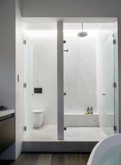 a bathroom with a tub, toilet and shower in it's center wall is shown