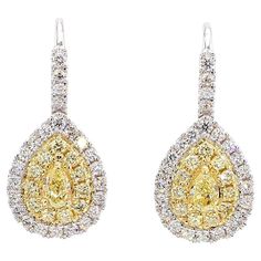 RareGemWorld's classic diamond earrings. Mounted in a beautiful 18K Yellow and White Gold setting with natural pear cut yellow diamonds. The yellow diamonds are surrounded by small round natural white diamond melee and small round natural yellow diamond melee. These earrings are guaranteed to impress and enhance your personal collection! Total Weight: 1.53cts   Length x Width: 23.8 x 10.8 mm Center Diamond Measurements: 5.0 x 3.0 mm Side Diamond Measurements: 1.5 - 1.7 mm  Natural Pear-Cut Yellow Diamonds  Natural Round White Diamonds Natural Round Yellow Diamonds 18K Yellow/White Gold All diamonds are guaranteed natural International Shipments: Please note that customers are responsible for all import duties and taxes applicable to the country of shipment Returns: Returns accepted in orig Classic Diamond Earrings, Earring Video, Yellow Gold Drop Earrings, Yellow Diamonds, Natural Cushions, White Gold Set, Cushion Diamond, Yellow Gold Setting, Pear Diamond