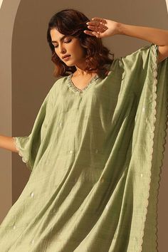 Light green handloom chiniya silk kaftan with sequins embroidery.
Components: 1
Pattern: Hand embroidered
Type Of Work: Sequins
Neckline: V Neck
Sleeve Type: Flared Sleeves
Fabric: Handloom chiniya silk
Color: Green
Other Details: 
Length :
Kaftan : 48 inches
Sleeve : 11 inches
Model Height : 5 ft 6 inches, wearing size S
Note : Pant worn by the model is not for sale.
Occasion: Sangeet - Aza Fashions Green Kaftan For Festivals With Traditional Drape, Festive Silk Kaftan With Gota Work, Bollywood Style Chanderi Kaftan With Dabka Work, Chanderi Kaftan With Mirror Work For Festivals, Summer Raw Silk Straight Kurta, Festival Chanderi Kaftan With Mirror Work, Summer Straight Kurta In Raw Silk, Green Saree-style Kaftan For Festivals, Green Kaftan With Dupatta For Diwali