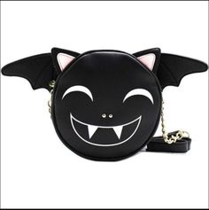 Betsey Johnson - Black Vampire Bat Crossbody Shoulder Bag Purse. Betsey Johnson 100% Authentic Style: Crossbody Style Name: Vampire Bat Color: Black Long Polyurethane And Gold Chain Shoulder Strap W 20" Drop. Posable Wings Top Zipper Closure W Gold Toned Signature Luv Betsey Lips Zipper Pull. Black & White Stripe W Pink Hearts Signature Luv Betsey Lining. 1 Main Inside Compartment New With Tags Mint Condition. Measurements: Length 7", Height 7", Width 3" Black Gothic Party Bags, Black Crossbody Bag For Halloween, Gothic Shoulder Bag For Halloween Party, Black Vampire, Betsey Johnson Handbags, Vampire Bat, Pink Crossbody Bag, Barrel Bag, Quilted Crossbody Bag