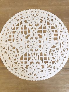 a white doily on a wooden table