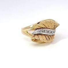 This Diamond and 14k Yellow Gold Retro Leaf Ring is the perfect way to add a touch of vintage flair to any ensemble. Crafted with a combination of 14k yellow gold and diamonds, this ring is sure to become a treasured piece of jewelry for many years to come. Jewelry Style : RingMetal Type : 14K Yellow GoldDiamonds : 6 round, single cutDiamond Weight : Approximately .040 ctwColor : H-IClarity : VS Size 6.5Stamped "14k 7G 302"Approximate Weight : 6.22 gramsRing Size : 6.75 Hallmarked Yellow Gold Diamond Ring, Vintage Yellow Gold Diamond Ring For Formal Occasions, Gold Diamond Cluster Ring Stamped 14k, Vintage Yellow Gold Diamond Ring With Brilliant Cut, Art Deco Diamond Ring Stamped 14k, Gold Vintage Round Cut Ring, Vintage Yellow Gold Rings With Diamond Accents, Vintage Yellow Gold Rings With Round Cut, Vintage Yellow Gold Round Cut Rings