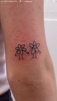 a tattoo on the arm of a woman with two flowers in each side of her arm