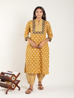 Mustard Yellow dabu flower printed straight kurta, has a mandarin collar, mirror and katha embroidered yoke, three-quarter sleeves and stripes Print afgani Pants has Elasticated Waistband Fabric: 100% Cotton Color: Mustard Yellow Note: Available in other colors Wash Care Instruction - Dry Clean Only The product will be shipped within 15-20 days of order placed Size Chart: Kurta Size XS S M L XL XXL XXXL Bust 36 38 40 42 44 46 Waist 32 34 36 38 40 42 Hip 38 40 42 44 46 48 Shoulder 14 14.5 15 15.5 Yellow Cotton Kurta With Printed Motifs, Mustard Kurta For Women, Semi-stitched Yellow Kurta With Printed Motifs, Yellow Mulmul Sets With Printed Motifs, Yellow Block Print Mulmul Sets, Quarter Sleeve, Mustard Yellow, Mandarin Collar, Three Quarter Sleeves