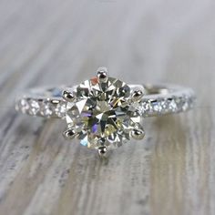 a diamond ring on top of a wooden table