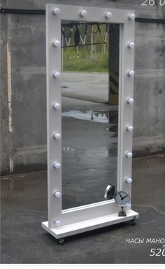 a white vanity mirror with lights on it