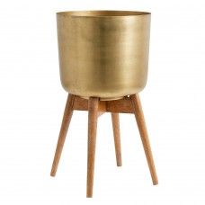 a large brass pot sitting on top of a wooden stand