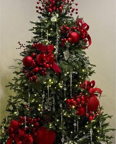 a decorated christmas tree with red ornaments