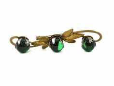 "Beautiful Art Nouveau or Art Deco period brooch with green glass spheres or orbs. Each sphere is held in place by the wide white metal prongs, giving a 2-tone effect, and allowing the sphere to turn freely. The glass spheres are not drilled in any way. The setting appears to be brass or something similar. Really a unique and visually stunning piece! Marked: No marks Measurements: 3.5\" x .75\" Condition: Excellent vintage condition. I try to find and tell you about any imperfections I see Pleas Antique Green Brooch For Evening, Juliana Jewelry, Glass Orb, Art Deco Art, Sun City, Purple Orchids, Deco Art, 1930s Art Deco, Expensive Jewelry