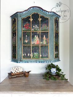 an old china cabinet is decorated with miniature figurines and other decorative items on the mantle