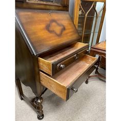 an antique wooden desk with drawers and mirror