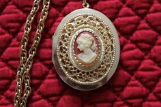 This vintage locket has a very pretty cameo.   It measures  46 mm x 38 mm.        I put this gorgeous locket on  a wonderful 22 1/8 inch gold plated  vintage rope chain.  I added a gold plated bail to the cameo and a gold plated toggle to finish the necklace.  This locket has a little wear on the back, but otherwise is in great vintage condition.  The chain is also in excellent vintage condition.  Together they make a beautiful necklace.   This necklace would make a lovely gift for any woman who wants to carry the photos of her loved ones next to her heart. Thank you for taking time out of your day to visit  KeepGrandmaBusy.  If you have any questions, please contact me through the etsy convo system. Evette Rice Cameo Medallion Locket Necklace, Cameo Medallion Locket Necklace For Weddings, Cameo Medallion Locket Necklace Keepsake, Cameo Medallion Locket Necklace For Keepsake, Vintage Locket Necklace For Valentine's Day Formal, Victorian Cameo Locket Necklace As A Gift, Victorian Locket Necklace With Hallmark As Gift, Cameo Medallion Necklace For Keepsake, Victorian Hallmark Locket Necklace Gift