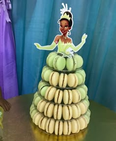 a cake made to look like a stack of macaroni and cheeses with a princess on top