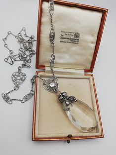 Please check my own website at www.elegantium.co.uk for my best prices :-) This is such a fabulous, early piece of c1900 English Arts and Crafts jewellery, with the most attractive leaves and berries design on the crystal drop, as well as the most wonderful detailing on the original sautoir chain. Clearly, all hand-constructed, every twist of the silver links, every oval openwork panel with coils and every hammered disc used in the design. A lovely piece in every sense. I have not been able to a Silver Drop Necklace For Evening, Silver Drop Necklaces For Evening, Silver Filigree Art Nouveau Necklace, Art Nouveau Silver Filigree Necklace, Antique Silver Teardrop Pendant Necklace, Silver Necklace With Intricate Art Nouveau Design, Antique Silver Necklace With Teardrop Pendant, Silver Victorian Necklace With Rose Cut Diamonds, Silver Briolette Drop Necklace For Formal Occasions