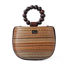 Introducing our new brown and tan Maria bag. This stunning bag offers a unique statement look with elevated luxury vacation moments in mind. You'll be sure to get admiring glances with this beautiful bag on your arm.  Crafted by artisans in the Philippines, this bag is created using woven Buntal straw - a natural and organic fiber from large leaves of abundant palm trees that are grown sustainably in the Philippines. Each piece of fiber is then meticulously handwoven to create a unique and natural textile that respects its origin.  The bag is complete with beaded top handles and  also comes with a detachable crossbody strap - perfect for when you need a hands free option. Made from Buntal weave and wooden beads Detachable crossbody strap Clean with a damp cloth Luxury Brown Box Bag For Travel, Luxury Brown Bucket Bag With Top Carry Handle, Natural Color Bags With Bamboo Handle For On-the-go, Natural Bags With Bamboo Handle For On-the-go, Brown Satchel With Round Handle For On-the-go, Luxury Bags With Bamboo Handle For On-the-go, Brown Straw Shoulder Bag For On-the-go, Chic Brown Handheld Box Bag, On-the-go Natural Bag With Detachable Strap