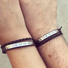 two people wearing bracelets with words on them