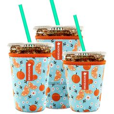 three cups with straws and orange slices on them