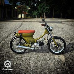 a yellow motorcycle parked on top of a parking lot