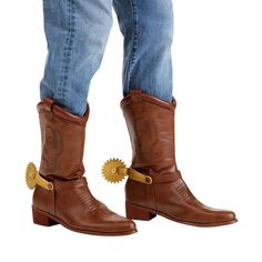 a pair of cowboy boots with spikes on the soles and jeans, both worn in brown leather