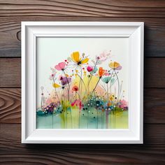 a painting on the wall with flowers painted in watercolor and white frame next to wood planks