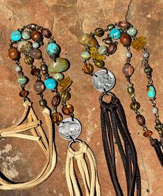 Vintage bronze sequence featuring: * Citrine and turquoise palette * Kingman turquoise nuggets * buffalo nickel lariat style * leather tassel (5 1/2 ") * Soft Napa leathers * Sterling silver slide bead (slide allows wearer to adjust length as desired) Total length (including tassel) = 48 inches    *Necklace total drop = 24 inches  ADJUSTABLE Limited quantities Artisan Brown Jewelry With Tassels, Bohemian Concho Lariat Necklace, Bohemian Lariat Concho Necklaces, Bohemian Lariat Concho Necklace, Bohemian Lariat Jewelry For Western-themed Events, Bohemian Brown Beaded Lariat Necklace, Bohemian Leather Lariat Jewelry, Turquoise Palette, Buffalo Nickel